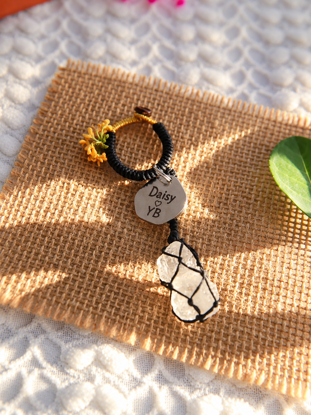 Black waxed cord bag charm with two natural Clear Quartz stones and a round tag engraved Daisy and YB with a heart