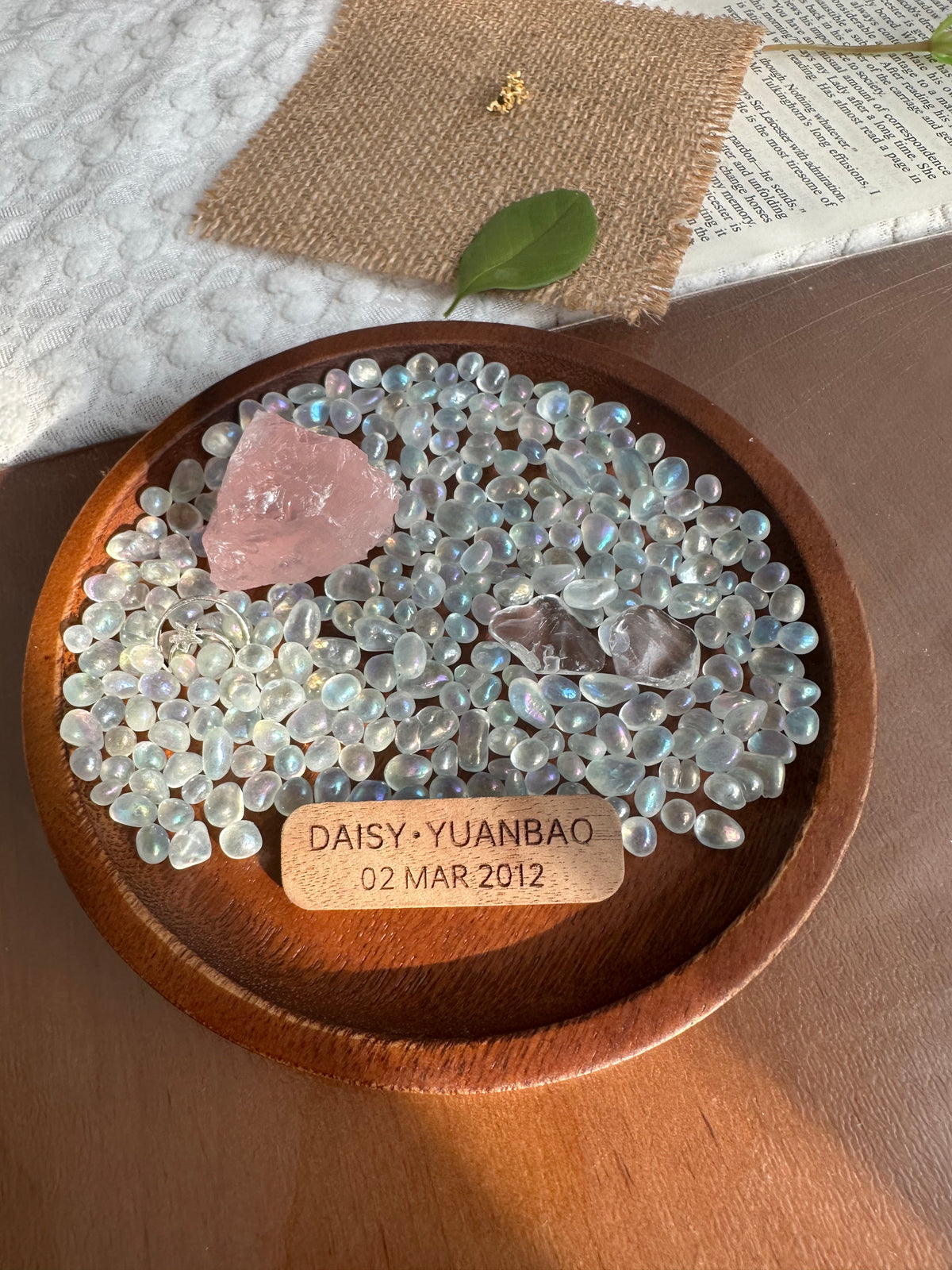 Rose quartz and moonstone in a walnut wood keepsake dish with an engraved wooden tag.