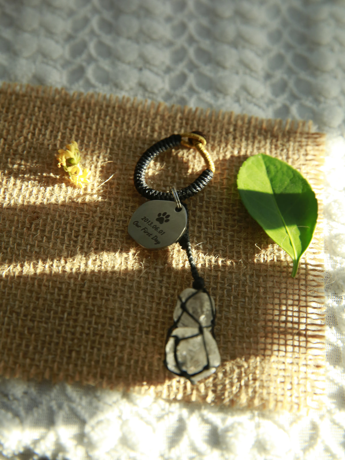 Black waxed cord double Clear Quartz bag charm showing the back of the personalized round tag