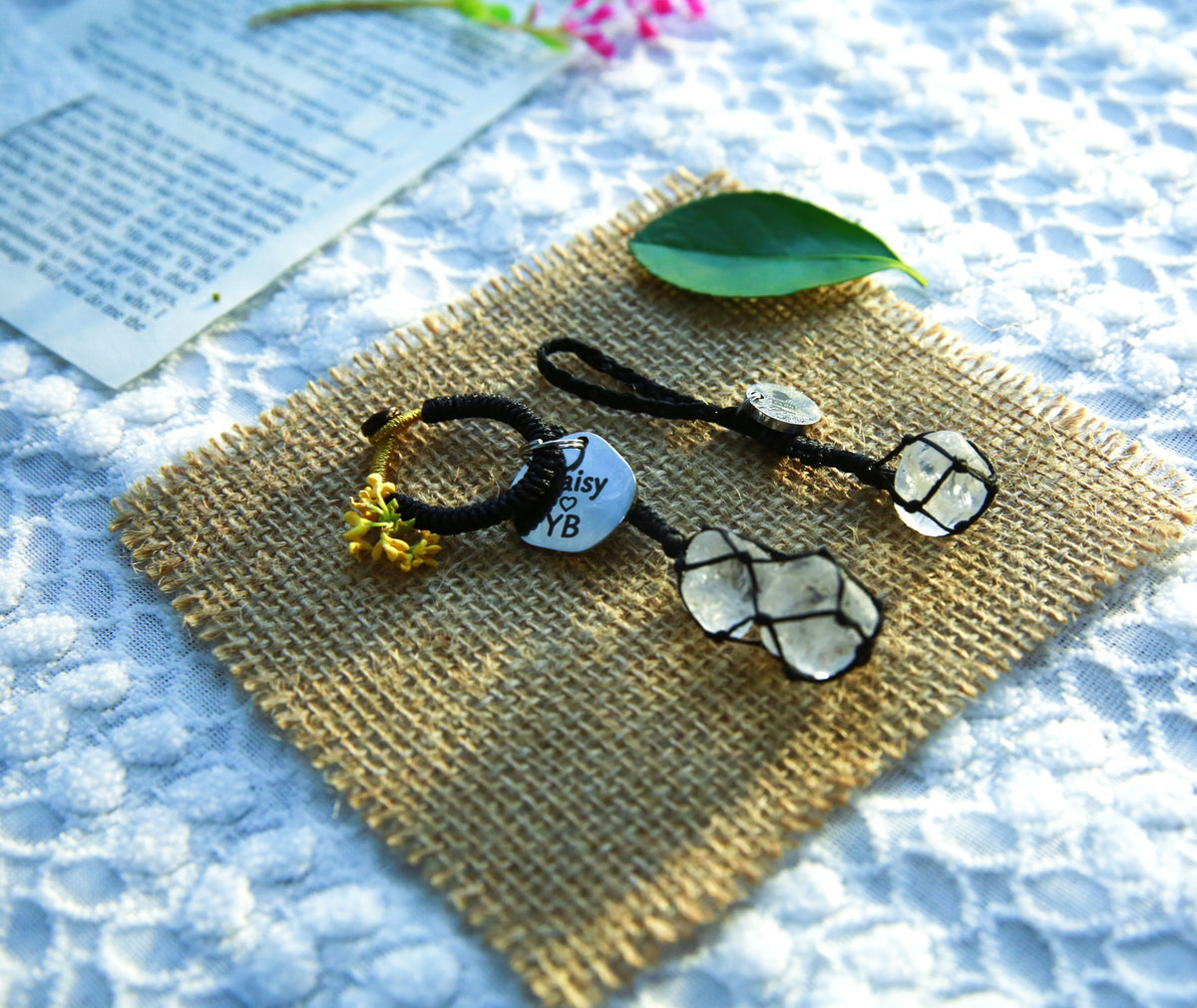 Black cord Clear Quartz pet and owner matching set on burlap, with a double-stone owner charm and a single-stone pet pendant