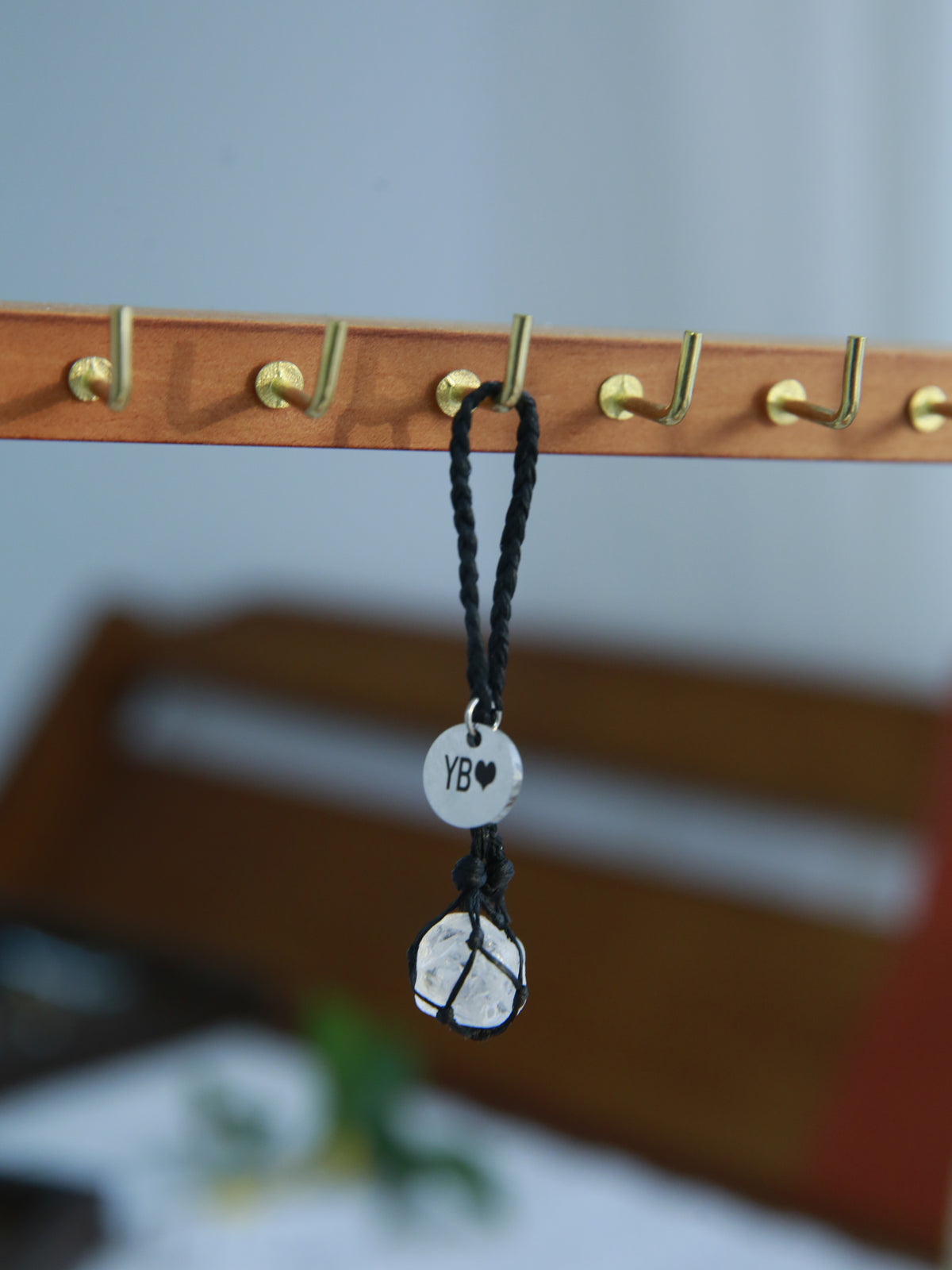 Single raw Clear Quartz pet pendant in black waxed cord with a personalized round tag and adjustable collar loop